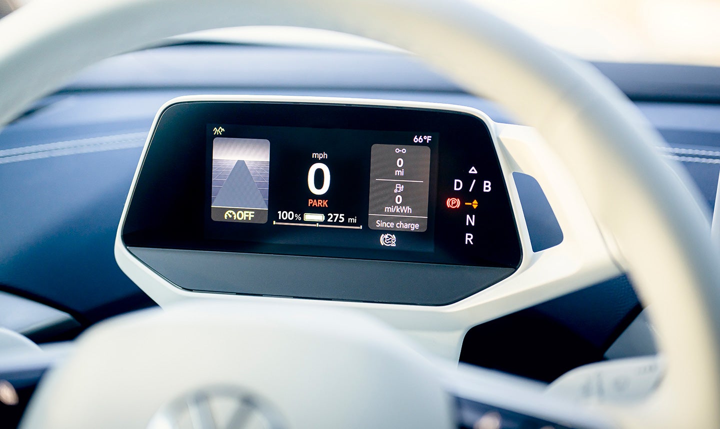 A close-up, of the Volkswagen ID.Cockpit digital instrument display behind the steering wheel, showing mile per hour and transmission gear graphics.